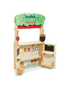 a wooden toy store with shelves and chalkboard on the front, including an apple tree