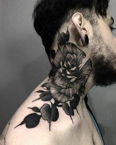 a man's neck tattoo with black flowers on the upper part of his neck