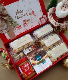 a red box filled with lots of cookies and other holiday treats on top of a table