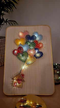 there is a wooden plate with some lights in the shape of flowers on it next to a bowl