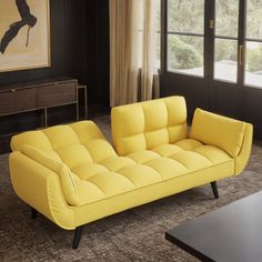 a yellow couch sitting in front of a window