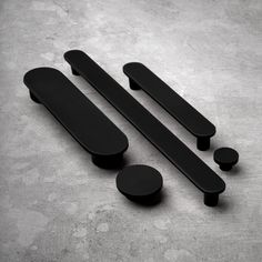 black handles and knobs on a concrete surface