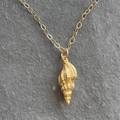 An 18 karat gold vermeil conch shell hangs from a 14k gold filled chain with 14k gold filled lobster clasp. Perfect for the Summer person in you! Please choose your length preference or the standard 18” will be dispatched. Your necklace will arrive beautifully giftboxed. Yellow Gold Charm Necklace With Lobster Clasp, 14k Gold Shell Jewelry For Gifts, 14k Gold-filled Yellow Gold Charm Necklace With Lobster Clasp, 14k Yellow Gold Filled Charm Necklace, Shell-shaped Charm Necklace As A Gift, Shell-shaped Charm Necklaces For Gift, Shell Charm Necklaces For Gift, Gold Shell Necklace With Delicate Chain For Gifts, Gold Shell Necklace With Delicate Chain As Gift