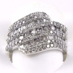 This Is A Round Bypass Diamond Cluster Lady's Ring Band. It Is Made Of 100% Natural 14kt White Gold And Is In Brand New Condition. It Has A Ctw Of 2.00ct And Weighs 6.5 Grams. The Fancy Diamonds Have A Clarity Of Si2 And F Color. This Beautiful Custom Piece Has Excellent Round Cut Diamond Stones That Form Into A Bypass Tangle Design With Brilliant Diamond Accents. Samson Diamond 100% Authentic Natural Diamonds, Gemstones, And Gold. Never Lab Created/Synthetic/Fake Merchandise. Luxury Diamond Bypass Ring With Diamond Accents, Luxury Diamond Bypass Ring With Round Cut, Luxury Cubic Zirconia Bypass Ring, Luxury Multi-stone Sterling Silver Cluster Ring, Luxury Diamond-cut Bypass Ring For Formal Occasions, Fancy Diamonds, Diamond Cluster Ring, Diamond Cluster, Brilliant Diamond