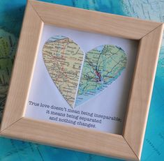 two hearts cut out of maps in a wooden frame on a map with the caption true love doesn't mean being unspeakable