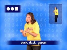 a woman standing in front of a blue background with numbers on it and the words duck, duck, goose