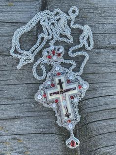 White Pearls & Red Crystallized Stone Pendant Devotional clergy Pectoral Cross filled with silver plating combined with pearl imitation glass beads small clear crystallized zircons, and red semi-precious stones. Religious Cross with Jesus enamel image, a long 23" elegant silver chain necklace with closure, worn as a vestment by bishops Cross pendant size (H X W): 16 cm x 7 cm / 6.3" x 2.7", Chain length: 60 cm / 23". Packed in a beautiful gift box with a velvet base to provide extra protection P White Rhinestone Cross Pendant Jewelry, White Cross Necklace With Rhinestones, White Cross-shaped Rhinestone Jewelry, White Cross-shaped Jewelry With Rhinestones, White Rhinestone Cross Jewelry, Spiritual Silver Necklaces With Rhinestones, Silver Crucifix Jewelry With Rhinestones, Silver Rhinestone Crucifix Jewelry, Spiritual Silver Jeweled Necklaces