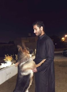 a man standing next to a dog on top of a roof