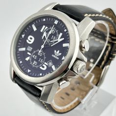 The Adidas Chronograph offers a balance between sports-inspired design and rugged styling.  Its oversized black dial and stainless case is instantly striking, while the rich leather gives it a classic feel This Adidas watch also features a chronograph movement. Ships immediately Adidas Watch, Wristwatch Men, Leather Band, Chronograph, Wrist Watch, Jewelry Watches, Black Leather, Adidas, Band