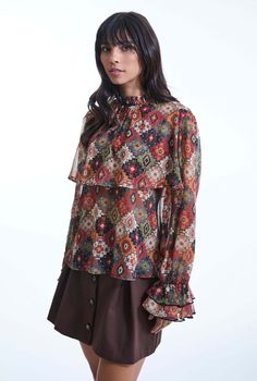 Add a touch of vintage charm to your wardrobe with this original printed blouse from James Lakeland. Crafted from sheer chiffon with gold threading, it features a 70’s inspired print. The long sleeves end in ruched, two-tiered ruffle cuffs, while a flowy panel graces the bust and back. The elegant ruffle collar fastens at the back with a single button, making it a standout piece for any occasion.     Made in Italy 100% Polyester Machine Wash at 30°C, Do not bleach, Permanent Press, Iron at Low Temperature, Dry Clean any solvent except trichloroethylene, Do Not Tumble Dry. Button Making, Shirt Blouses Women's, September Birthstone Jewelry, Gifts For New Mums, Ruffle Collar, Pearl Jewellery Earrings, Sheer Chiffon, Chiffon Blouse, Eye Jewelry