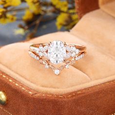 a diamond ring sitting on top of a velvet box