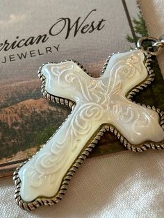 Carolyn Pollack American West carved mother of pearl sterling ornate cross enhancer vintage never worn with care card  Cross is 2" Vintage White Cross Jewelry, Vintage White Jewelry For Memorial, Ornate Cross, American West, Care Card, Pendant Necklaces, Mother Of Pearl, Favorite Jewelry, Jewelry Necklace Pendant