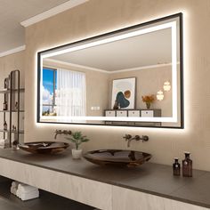 a bathroom with two sinks and a large mirror on the wall over it's counter