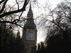 the big ben clock tower towering over the city of london, england in winter time