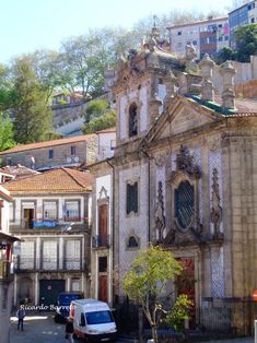 an old church in the middle of a small town with lots of buildings on it