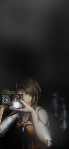 a woman holding a camera in front of her face