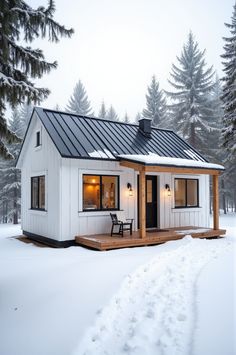 Discover the warmth of a Scandinavian-style cottage nestled in a snowy landscape. This minimalist retreat offers serene Nordic living with picture windows framing stunning views. #HyggeHome #ScandinavianDesign White A Frame House Exterior, Small Farm Homes, Rustic Tiny House Cabin, Scandinavian Bungalow, Cottage In Snow, Black Metal Roof, Dream Photos, Scandinavian Cabin, Cozy Scandinavian