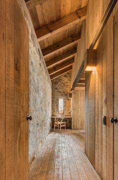 an empty room with wooden floors and walls