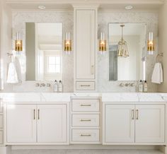 a large bathroom with two sinks and mirrors