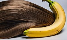 a banana and some brown hair on a gray background