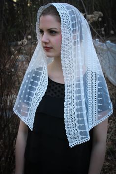 A veil in honor of Our Lady, Star of the Sea (Latin: Stella Maris) An incredibly soft and light veil. This is a lovely and soft fabric, strewn with tiny star-flowers. The delicate flowers are scattered over the entire veil, and the edge is embroidered around the face. Finished with a string-of-pearls Venice trim at the hem. This generously-sized rounded triangle veil measures about 50 x 21 inches. Also in an infinity style and wrap styles. Choose from white, ivory, or black at checkout. https:// White Lace Trim Veil For Ceremony, Bohemian White Lace Dupatta, White Bohemian Lace Dupatta, Traditional White Veil, White Lace Shawl For Wedding, White Delicate Lace Veil For Ceremony, White Sheer Dupatta Shawl For Weddings, White Lace Trim Shawl For Wedding, Bohemian White Dupatta For Wedding