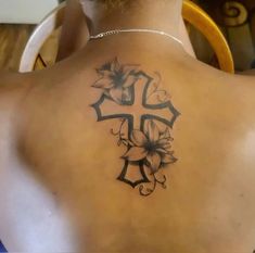 a man with a cross tattoo on his back