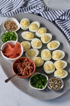 how to make deviled egg board with eggs and other ingredients on a platter