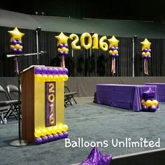 balloons are placed on the stage for an event