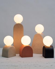 three different types of lights sitting next to each other on top of a white surface