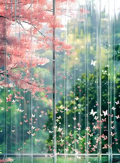 a tree with pink flowers in front of it and rain falling down on the ground