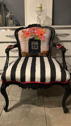 a black and white striped chair with flowers on it