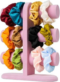 an assortment of different colored scrunffles on a pink stand