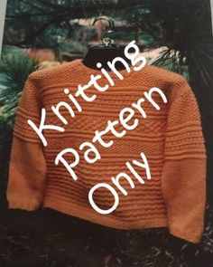 an orange knitted sweater hanging from a tree with the words knitting pattern only written on it