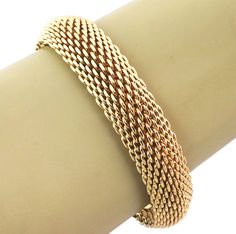 This gorgeous authentic bracelet is by Tiffany & Co. from their Somerset collection, the 15mm wide mesh flexible band is crafted from 18k yellow gold in a fine polished finish. It is hallmarked with the designer name and metal content. Brand: Tiffany & Co. Hallmark: Tiffany & Co. 750 Measurement: inner circumference: 7.5" x 15mm wide x 6mm thick Material: 18k yellow gold Weight: 88.5 grams Tiffany Gold, Modern Bracelets, Designer Name, Mesh Bracelet, Fine Jewelry Bracelets, Tiffany And Co, Somerset, Tiffany & Co., Arm Band