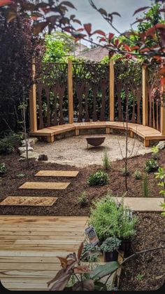 a wooden bench sitting in the middle of a garden