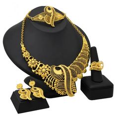 Indulge in luxury with this exquisite Dubai Gold Necklace Set, perfect for wedding parties. With its opulent design and superior craftsmanship, this set features a necklace, bracelet, earrings, and ring. Make a lasting impression and elevate your style with this luxurious jewelry set." Elegant Alloy Jewelry As Gift, Formal Plated Alloy Jewelry, Gold Alloy Jewelry With Elegant Design, Gold Fine Jewelry For Wedding, Elegant Gold Alloy Jewelry, Yellow Gold Alloy Party Jewelry, Gold Plated Jewelry For Wedding, Yellow Gold Plated Jewelry For Wedding, Elegant Gold Alloy Bridal Necklace