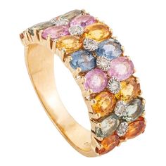 a yellow gold ring with multicolored stones