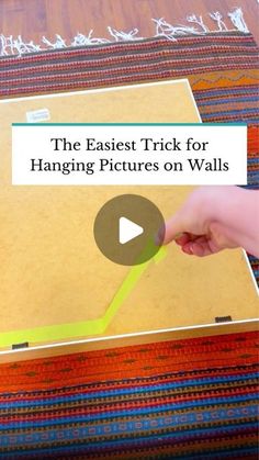 the easyest trick for hanging pictures on walls is to use tape and adhesive