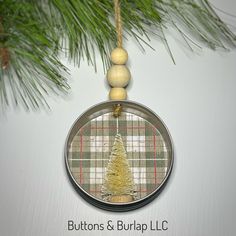 a christmas ornament hanging from a pine tree