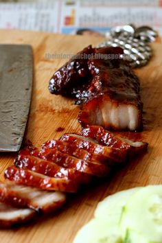 sliced up meat sitting on top of a wooden cutting board