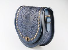 "Blue bag with metal, round leather bag, embossed bag, blue leather purse, crossbody bag, tooled blue bag, gift for her, shoulder purse Model \"Guelder rose\"+metal Unique handmade bag made of premium 4 mm genuine calf leather. Made using rare technology of hot tooling. Ornamented with grape vines and cluster of grapes images, decorated with metal. Super comfortable, durable and functional. Has one big compartment, one internal zip-pocket and one button pocket, e.g. for cell phone or keys. Dimen Hand-tooled Blue Crossbody Shoulder Bag, Hand Tooled Blue Crossbody Bag, Blue Leather Hand Tooled Shoulder Bag, Blue Hand Tooled Leather Shoulder Bag, Hand Tooled Blue Leather Shoulder Bag, Grapes Images, Guelder Rose, Grey Crossbody Bag, Red Leather Purse