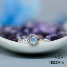 This beautiful Sterling Silver Rainbow Moonstone Promise Ring has an elegant vintage style that is certain to please. It features a Moonstone cabochon with a fancy rose cut and plenty of blue flash. We are happy to create this ring for you in a variety of sizes and finish options. This lovely ring features a bright and sparkling stone, framed by a Sterling Silver Gallery Wire Bezel which both protects and enhances. The band has been created from a gently hammered round wire. The band measures 1 Sterling Silver Moonstone Ring, Ring Moonstone, Moonstone Ring Sterling Silver, Moonstone Cabochon, Buy Jewellery Online, Textured Ring, June Birthstone, Lovely Ring, Quartz Ring