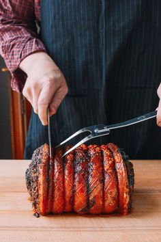 a person cutting up some meat with a knife