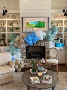 a living room filled with furniture and balloons hanging from the ceiling over a fire place