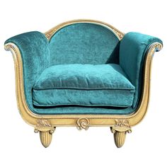 a blue velvet chair with gold trimming