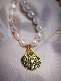 This chunky white freshwater pearl statement necklace evokes visions of Hawaii's white sandy beaches and reflects Hawaii's natural abundance. It features large freshwater pearls and a stunning gold shell pendant. This unique beauty is ready for you and your tropical escape.✦ DETAILS ✦✧ Name: Kawai (KAH wie) - coming from water.✧ Choose your length.✧ White Freshwater Pearl beads✧ Large Brass Seashell Pendant.✧ 14kt Gold Filled components and clasp.✧ All Ke Aloha Jewelry pieces come packaged thoug Pearl Necklace With Gold, Seashell Pendants, Pearl Statement Necklace, Tropical Escape, White Pearl Necklace, Unique Beauty, White Freshwater Pearl, Shell Pendant, Sandy Beaches