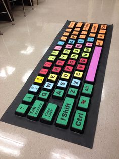 a colorful keyboard is sitting on the floor