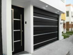 a black and white garage door next to a building