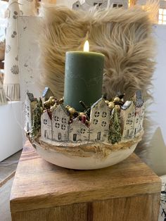 a candle that is sitting on top of a bowl