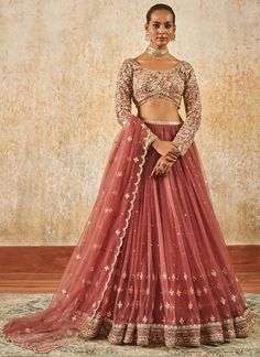 Our Dusty Rose Embroidered Lehenga includes a net top with santoon inner, net bottom with santoon inner, and a net dupatta. Embroidery is present on this style using zari, sequins, and thread work.  Like all of our pieces, this piece is made in India and checked by hand to ensure high quality. Rose Gold Lengha, Dusty Rose Lehenga, Elegant Pink Embroidered Lehenga, Mauve Pink Lehenga, Unstitched Pink Embroidered Lehenga, Pink Floral Embroidered Semi-stitched Lehenga, Dupatta Embroidery, Net Top, Embroidered Lehenga